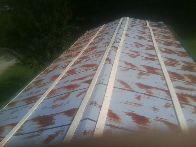 Rusted metal roof panels with new wood purlins before replacement — Storm Damage Roof Repair in Otter Creek by Roofing Brothers
